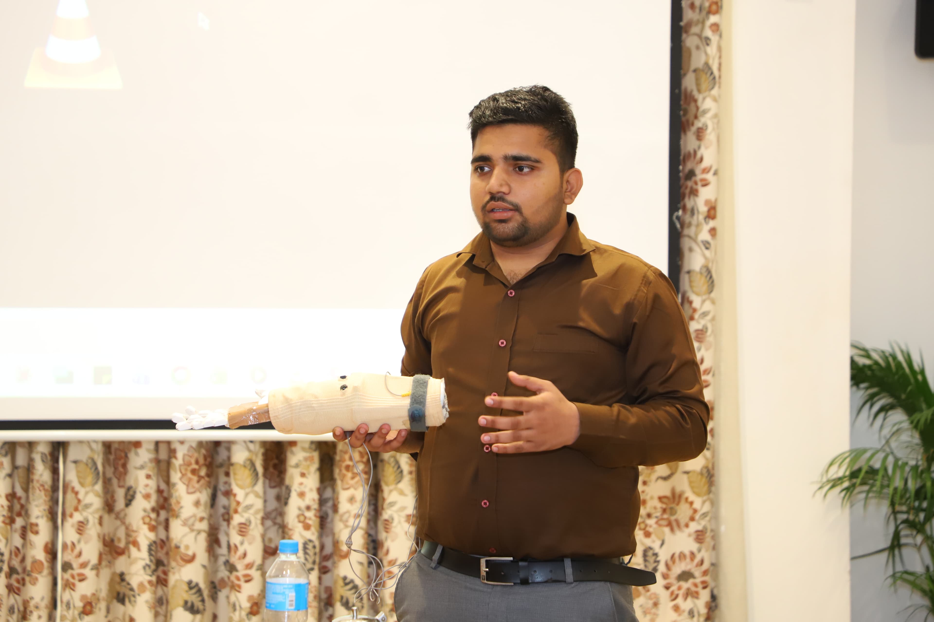 Team member demonstrating the SAKSHAM prosthetic prototype.